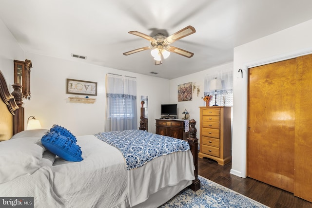 bedroom with dark hardwood / wood-style flooring and ceiling fan