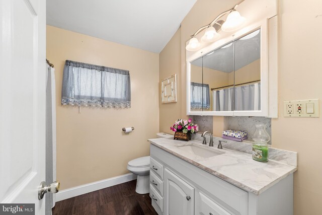 bathroom featuring vanity, hardwood / wood-style floors, and toilet