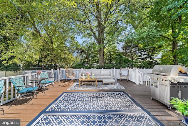 wooden terrace featuring grilling area and an outdoor hangout area