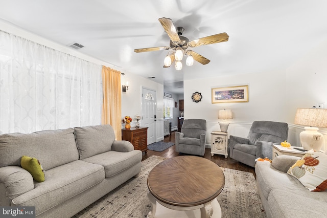 living room with ceiling fan and hardwood / wood-style floors