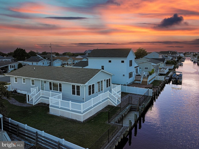 exterior space with a yard and a deck with water view