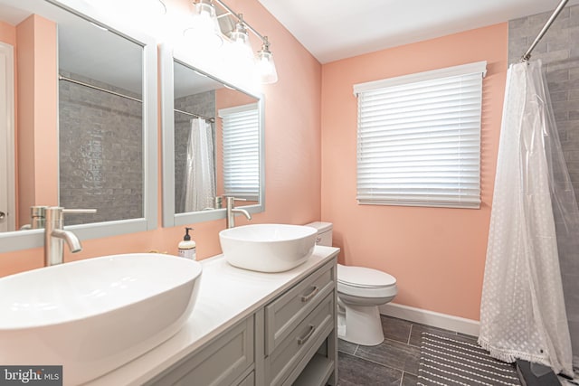 bathroom featuring walk in shower, vanity, and toilet