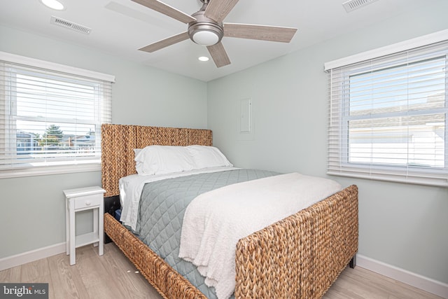 bedroom with ceiling fan and light hardwood / wood-style floors