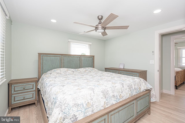 bedroom with ceiling fan and light hardwood / wood-style flooring