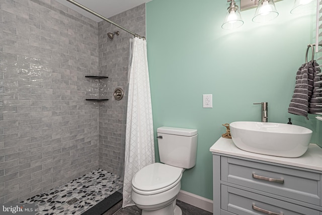 bathroom featuring walk in shower, vanity, and toilet