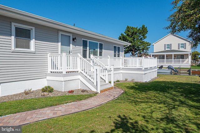 exterior space with a wooden deck and a front yard