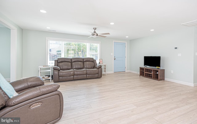 living room with light wood-type flooring and ceiling fan