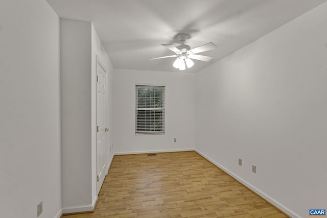 spare room featuring light hardwood / wood-style floors and ceiling fan