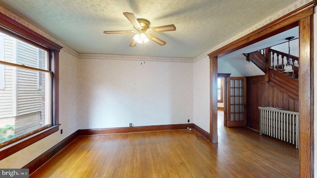 spare room featuring ceiling fan, a textured ceiling, and wood-type flooring