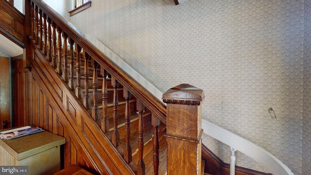 stairs with wallpapered walls