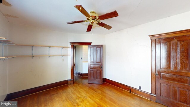 unfurnished bedroom featuring baseboards, ceiling fan, and light wood finished floors