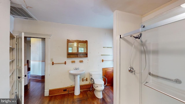 bathroom featuring toilet, hardwood / wood-style floors, and sink