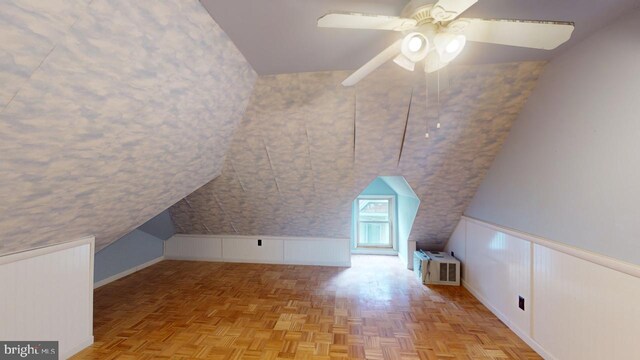 additional living space featuring lofted ceiling, light parquet floors, and ceiling fan