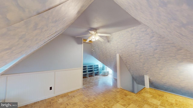 bonus room featuring ceiling fan, light parquet flooring, and vaulted ceiling