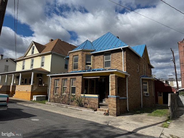 view of front of house with covered porch and cooling unit