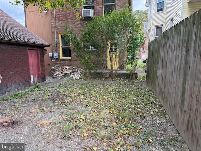 view of yard featuring fence and cooling unit