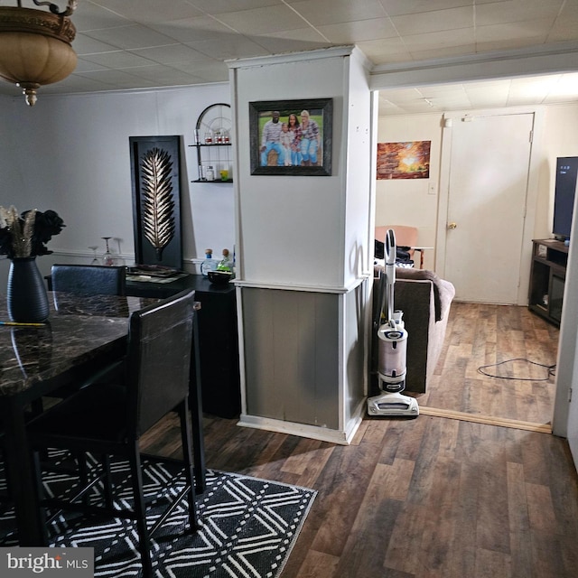 kitchen featuring dark wood-type flooring and a paneled ceiling