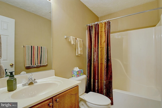 full bathroom with vanity, shower / bath combination with curtain, a textured ceiling, and toilet