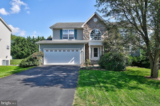 view of front property featuring a garage and a front yard