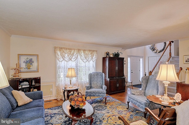 living room featuring light wood-type flooring and ornamental molding