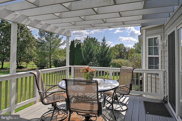 deck with a pergola and a lawn