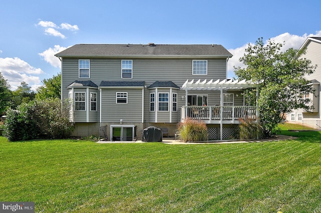 back of property featuring a pergola, a yard, and a deck