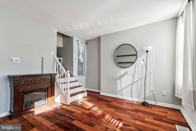 unfurnished living room with dark hardwood / wood-style flooring