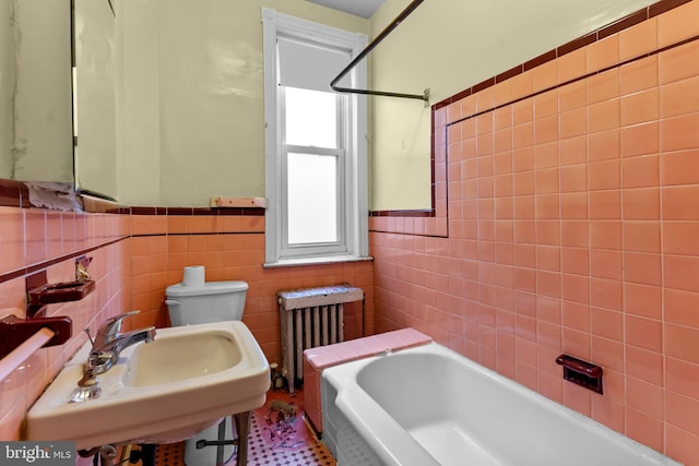 full bathroom featuring radiator, sink, tile walls, and toilet