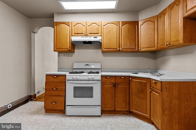 kitchen featuring white range with gas cooktop and sink