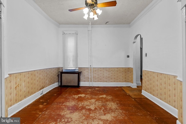 spare room featuring ceiling fan, ornamental molding, and a textured ceiling