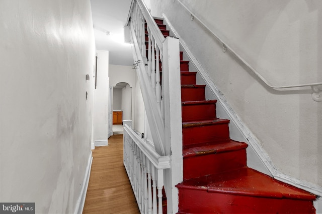 stairway featuring wood-type flooring