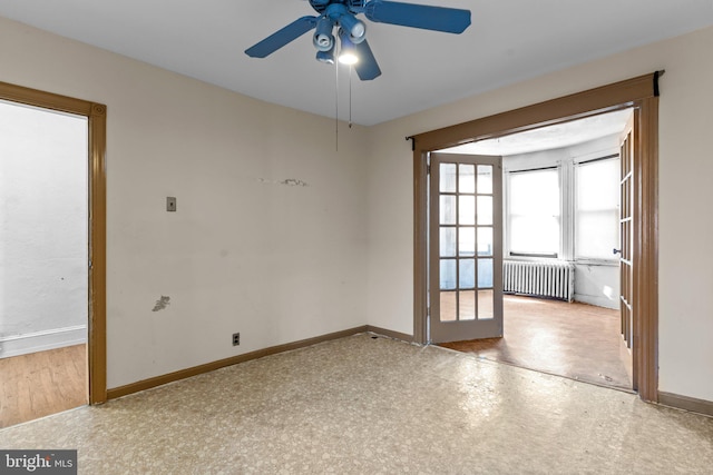 empty room with ceiling fan, radiator, and hardwood / wood-style flooring