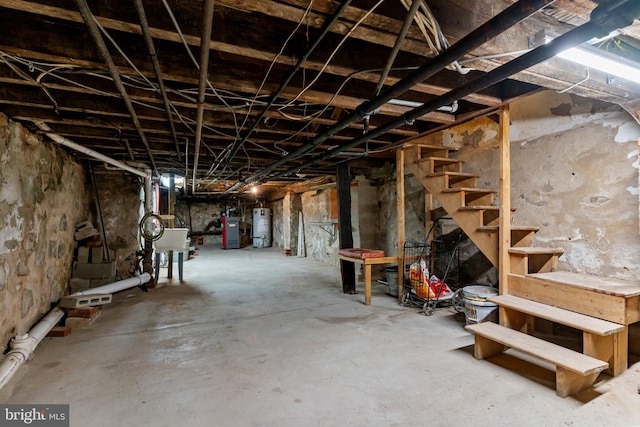 basement with water heater and sink