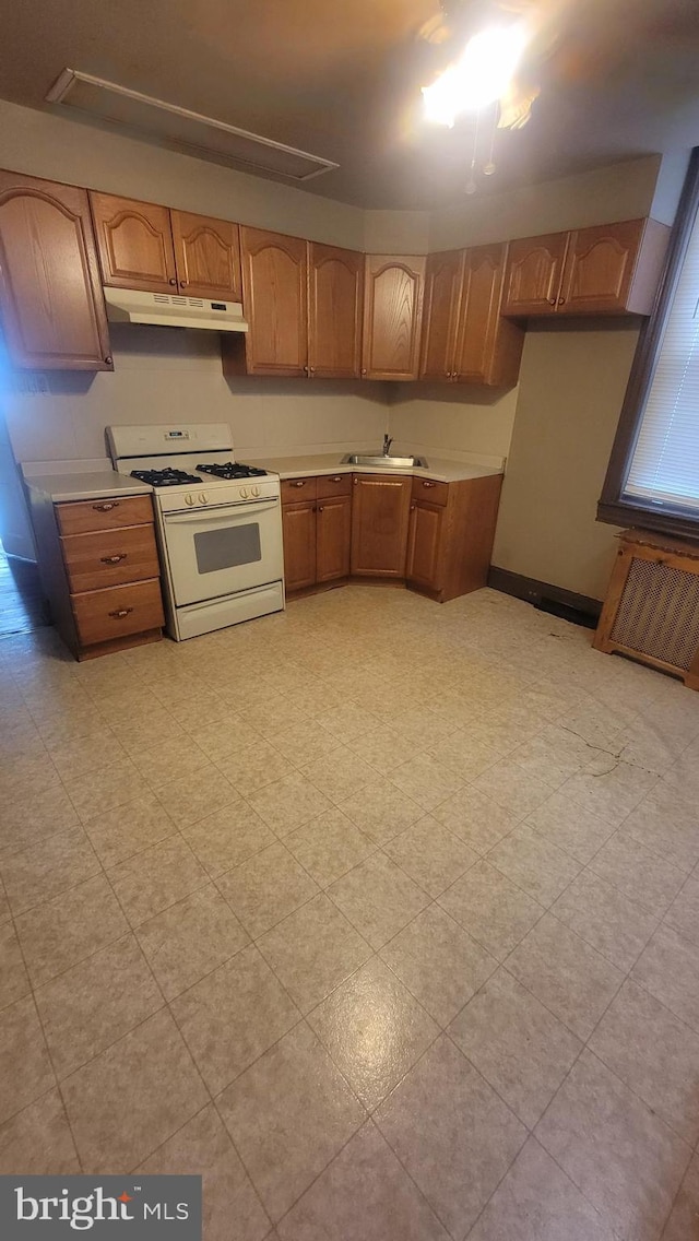 kitchen featuring sink and white gas range