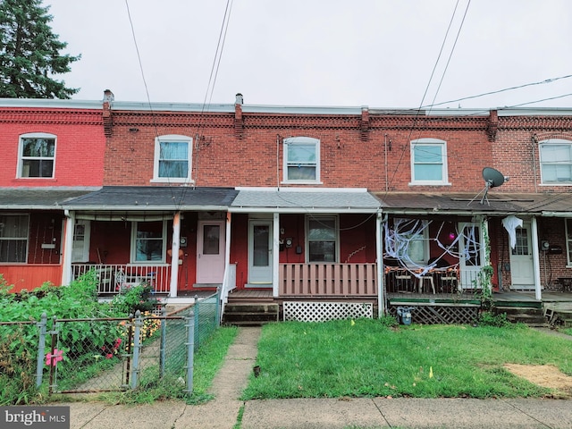 view of property featuring a front yard and a porch