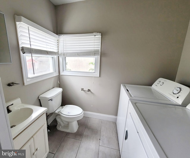 bathroom with vanity, washer and dryer, and toilet