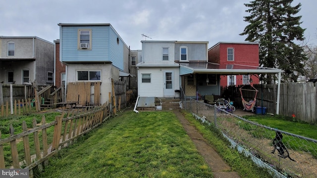 back of house featuring a lawn and cooling unit