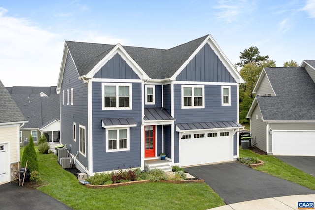 view of front facade featuring central air condition unit, a front yard, and a garage