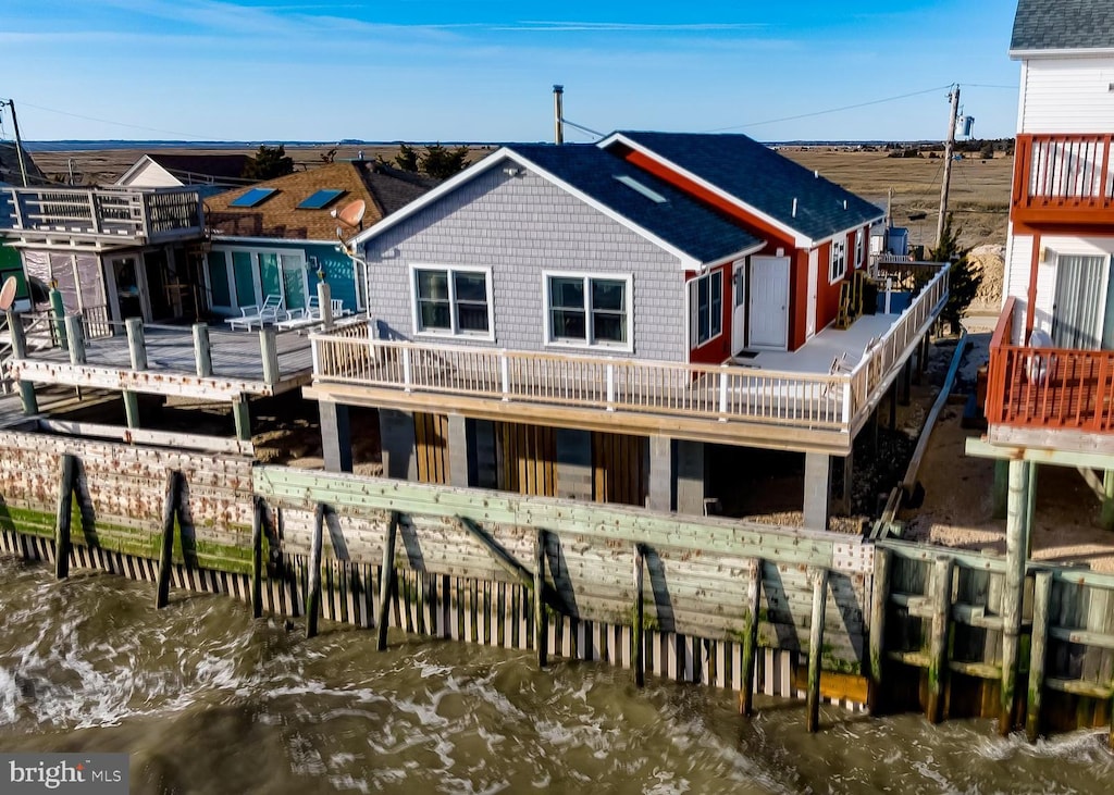 back of house featuring a deck with water view