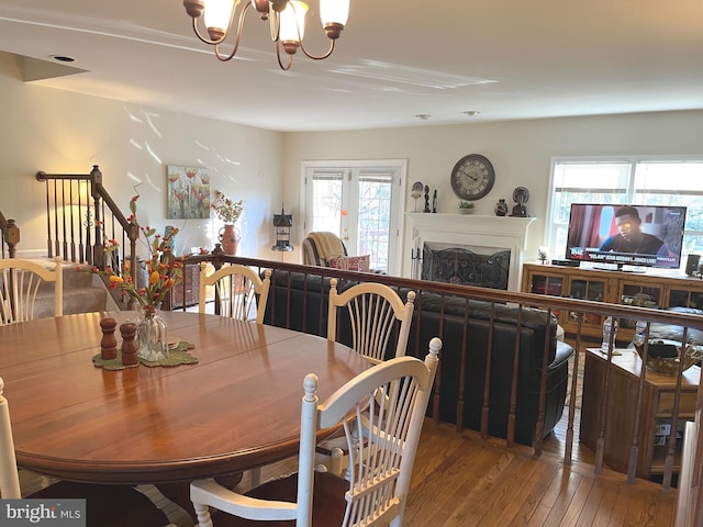 dining space featuring a notable chandelier and hardwood / wood-style flooring