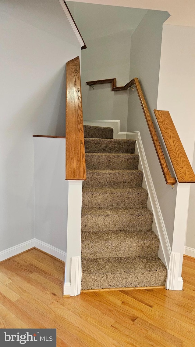 stairs with hardwood / wood-style floors