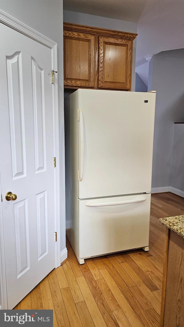 laundry room with light wood-type flooring