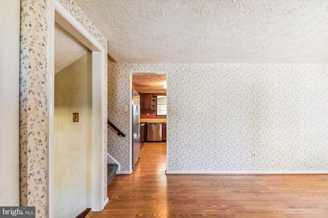 interior space featuring wood-type flooring and a textured ceiling