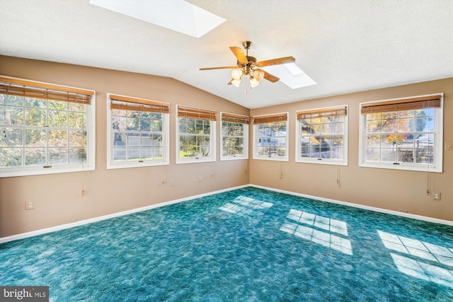 unfurnished sunroom with vaulted ceiling with skylight and ceiling fan