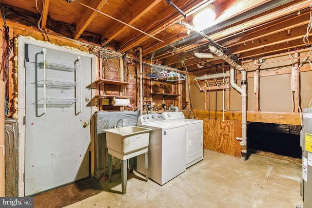 clothes washing area with sink and washing machine and clothes dryer