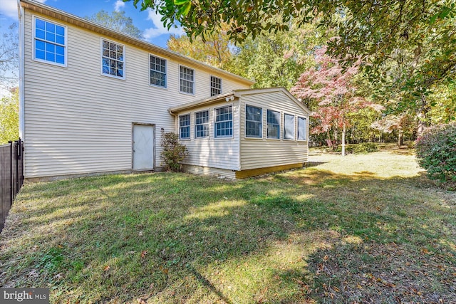 back of house featuring a lawn