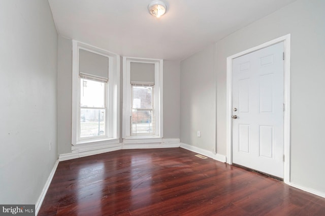 spare room with dark wood-type flooring