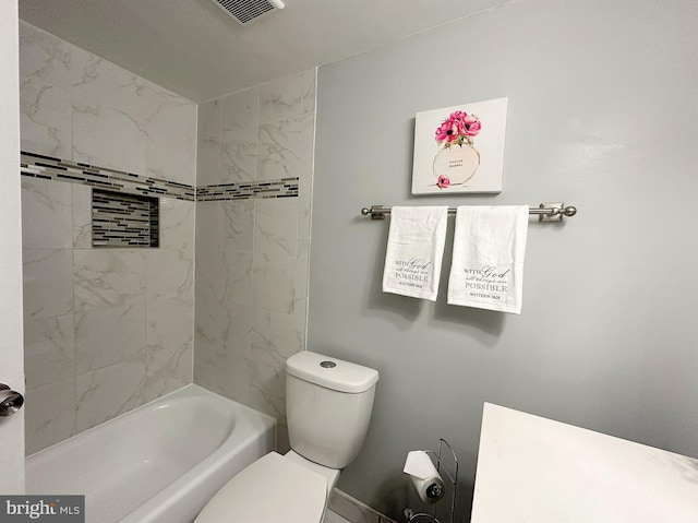 full bathroom featuring toilet, tiled shower / bath combo, and vanity