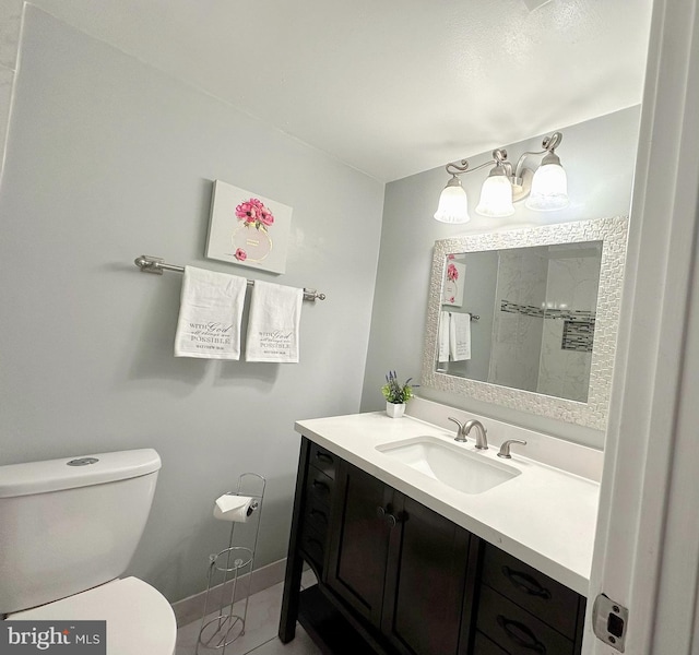 bathroom featuring vanity, toilet, and tile patterned flooring