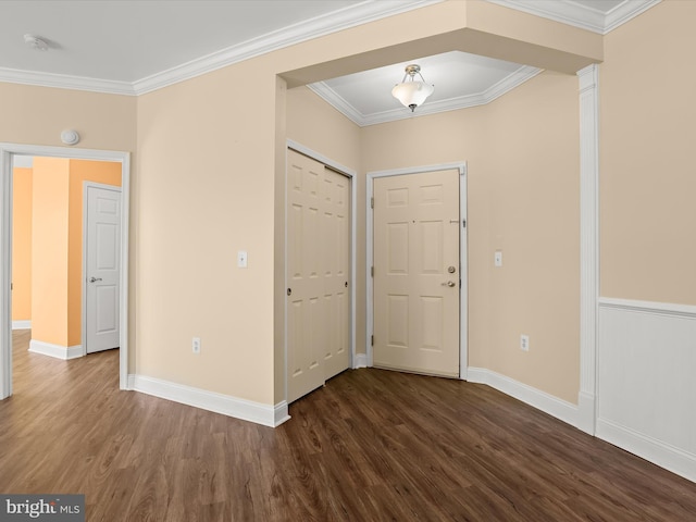 entrance foyer featuring ornamental molding and dark hardwood / wood-style floors